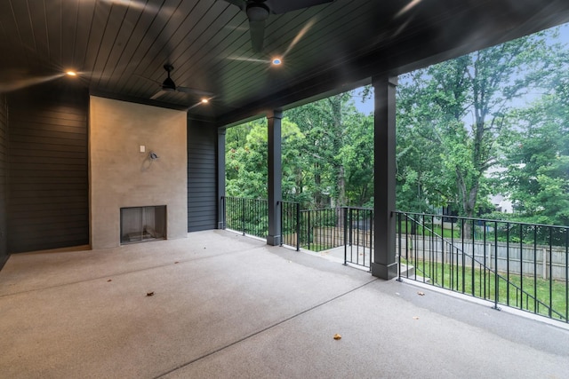 view of patio featuring ceiling fan and an outdoor fireplace