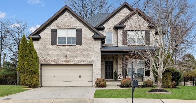 view of front of home with a front yard and a garage