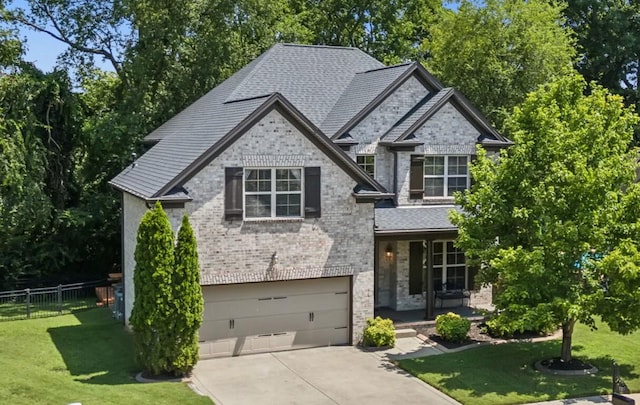 view of front of property featuring a garage and a front lawn