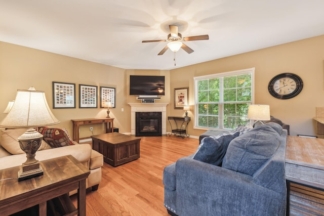 living room with light hardwood / wood-style flooring and ceiling fan