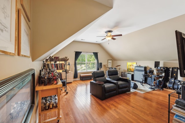 living room featuring hardwood / wood-style flooring, ceiling fan, and lofted ceiling