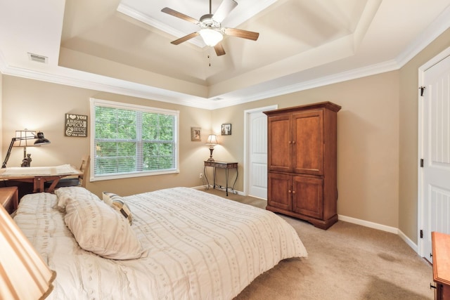 carpeted bedroom featuring a raised ceiling, ceiling fan, and crown molding