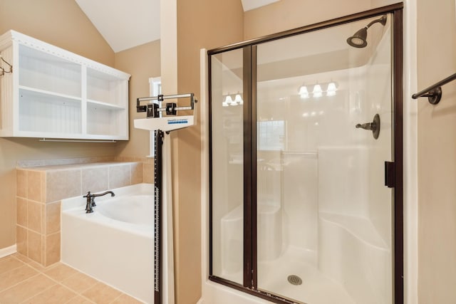 bathroom featuring tile patterned floors, separate shower and tub, and vaulted ceiling