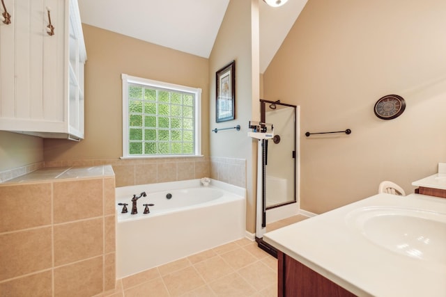 bathroom featuring tile patterned flooring, vanity, vaulted ceiling, and separate shower and tub