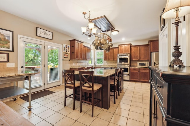 kitchen featuring decorative backsplash, stainless steel appliances, and a healthy amount of sunlight