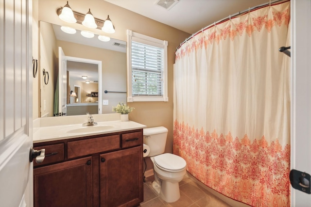 bathroom featuring tile patterned floors, vanity, and toilet