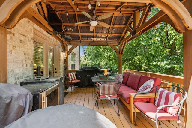 wooden terrace featuring area for grilling and outdoor lounge area