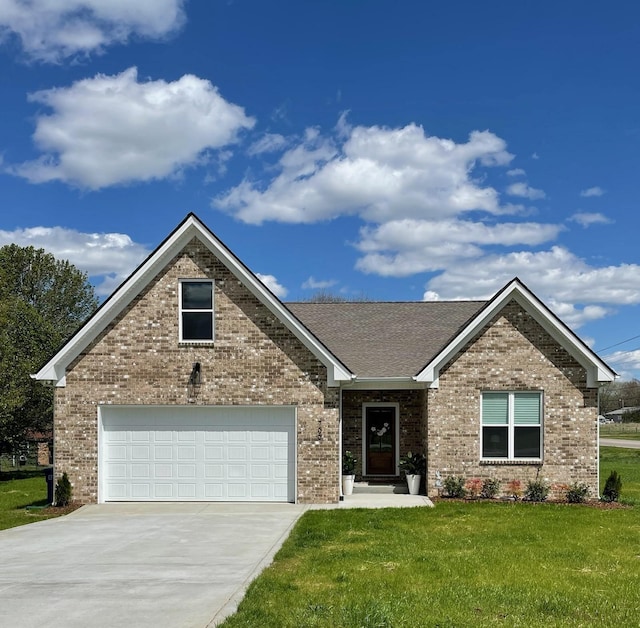 view of front of home with a front yard and a garage