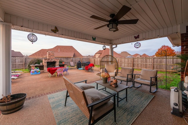 view of patio with an outdoor living space with a fireplace and ceiling fan