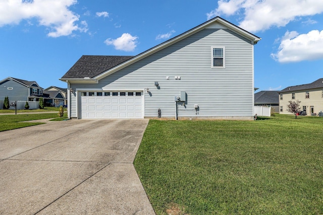 view of side of home with a garage and a yard