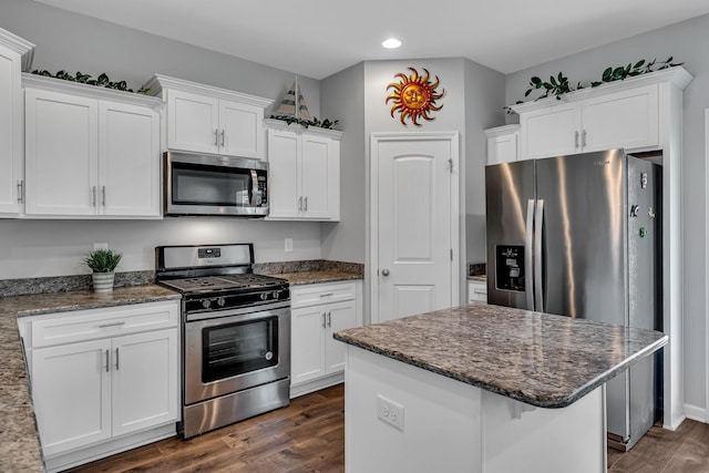 kitchen with white cabinets, dark hardwood / wood-style flooring, and appliances with stainless steel finishes