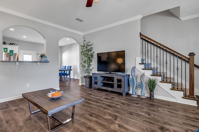 living room with ceiling fan, ornamental molding, and dark wood-type flooring