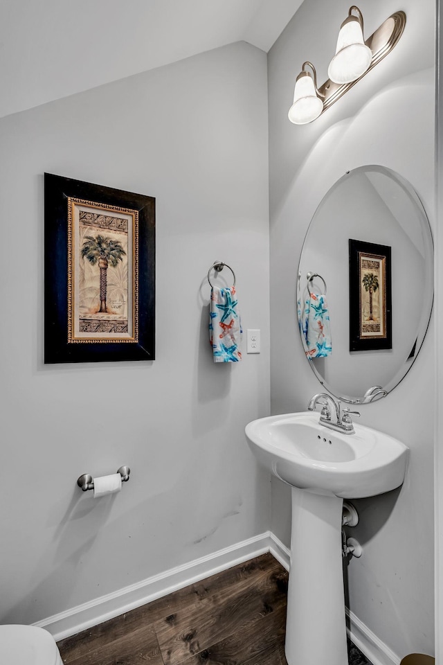 bathroom with hardwood / wood-style flooring and lofted ceiling