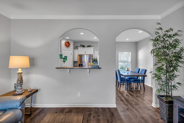 interior space featuring dark hardwood / wood-style floors and crown molding