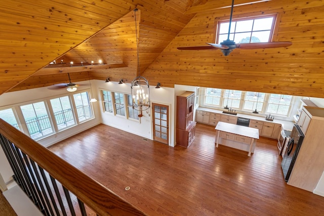 unfurnished living room with hardwood / wood-style floors, ceiling fan with notable chandelier, wooden ceiling, and high vaulted ceiling