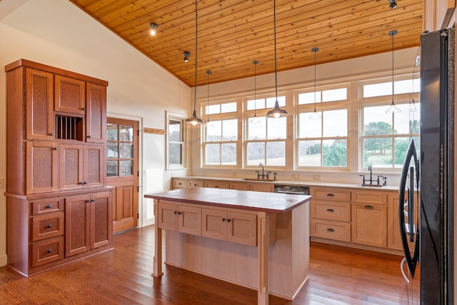 kitchen featuring sink, wooden ceiling, wood-type flooring, black refrigerator, and a kitchen island