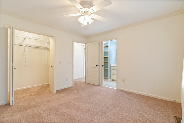 unfurnished bedroom with a closet, ceiling fan, crown molding, and light colored carpet