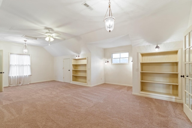 bonus room featuring ceiling fan, lofted ceiling, and light carpet