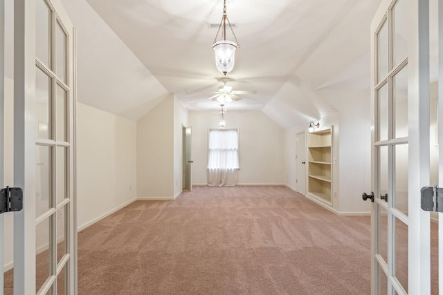 additional living space with light carpet, french doors, ceiling fan, and lofted ceiling