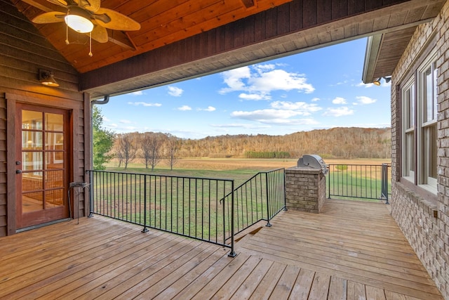 deck with ceiling fan and a lawn