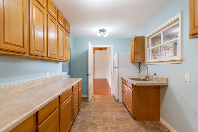 kitchen featuring white fridge and sink