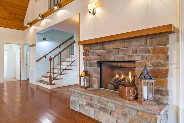 interior details featuring a stone fireplace and wood-type flooring