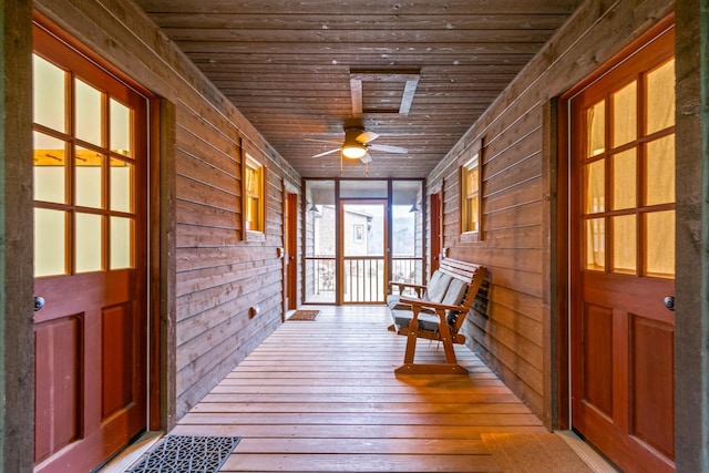 unfurnished sunroom featuring ceiling fan and wood ceiling