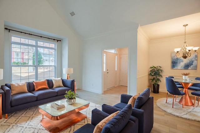 living room featuring ornamental molding, high vaulted ceiling, light hardwood / wood-style floors, and a notable chandelier