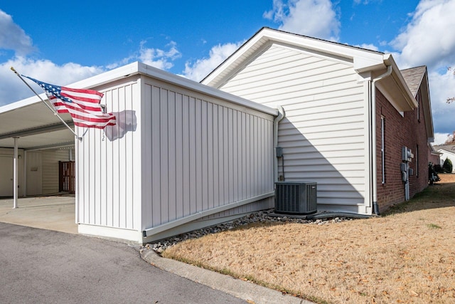 view of side of property with central air condition unit and a carport