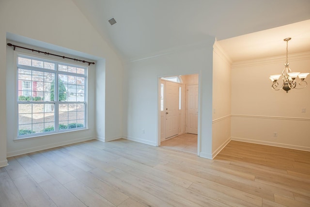 spare room with ornamental molding, light hardwood / wood-style floors, an inviting chandelier, and lofted ceiling