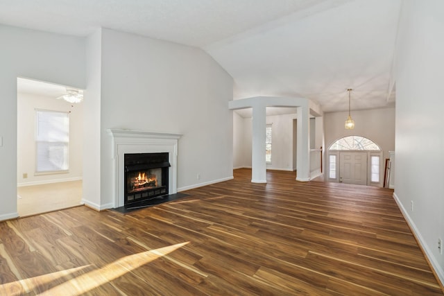 unfurnished living room with dark hardwood / wood-style flooring and high vaulted ceiling