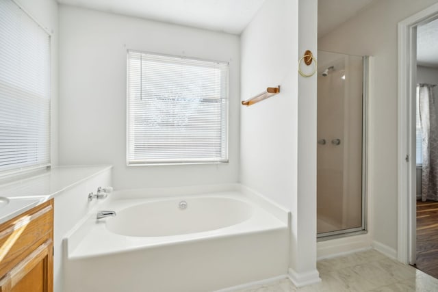 bathroom featuring vanity and separate shower and tub