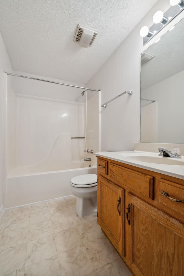 full bathroom featuring vanity, shower / bathing tub combination, a textured ceiling, and toilet