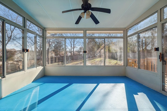 unfurnished sunroom with ceiling fan