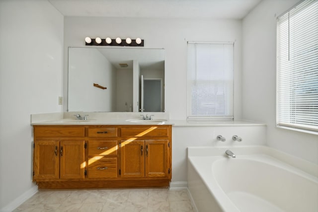 bathroom with vanity and a washtub