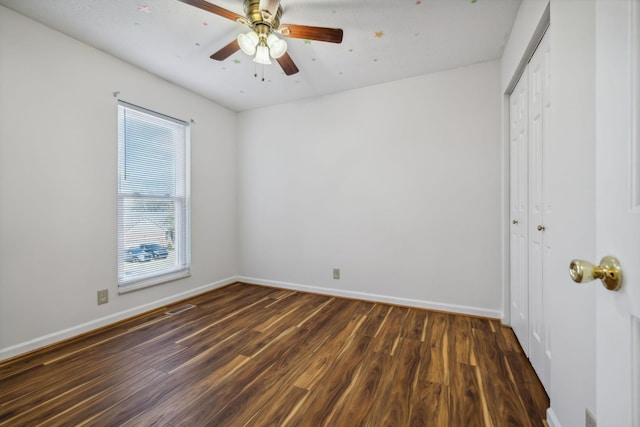 unfurnished room with ceiling fan and dark hardwood / wood-style floors