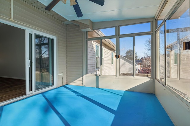 unfurnished sunroom with ceiling fan