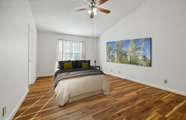 bedroom with vaulted ceiling, dark wood-type flooring, and ceiling fan