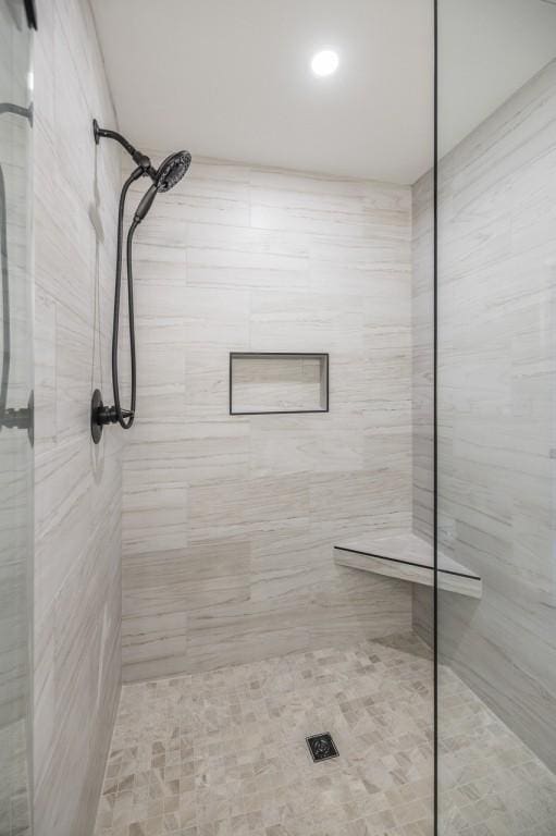 bathroom with a tile shower