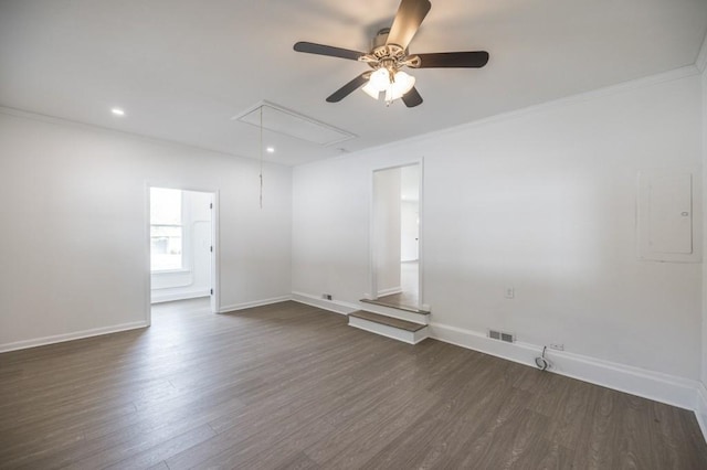 empty room featuring electric panel, ceiling fan, crown molding, and dark wood-type flooring