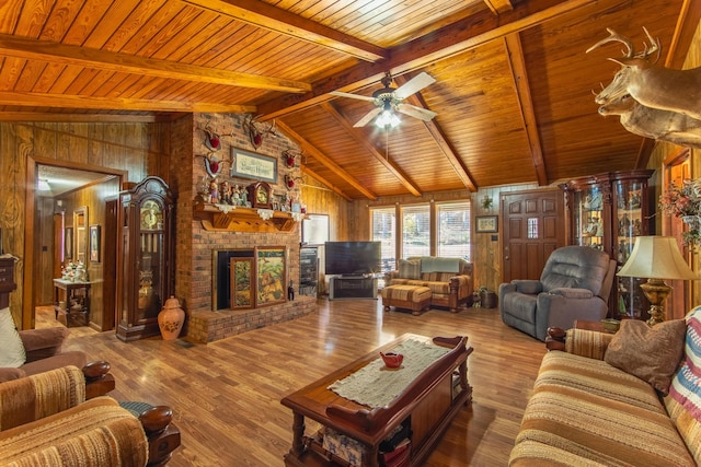 living room with vaulted ceiling with beams, wood walls, wood-type flooring, and wooden ceiling