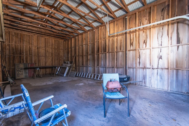 misc room with concrete floors and vaulted ceiling