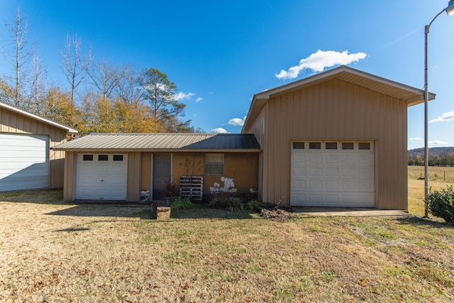 view of front of property with a garage and a front yard