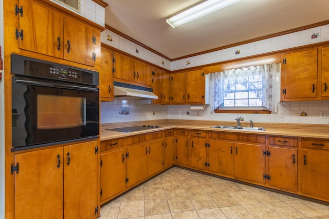 kitchen featuring black appliances, ornamental molding, sink, and tasteful backsplash