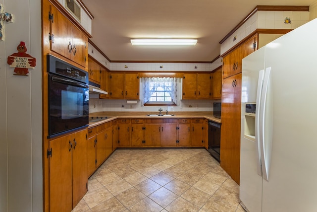 kitchen featuring sink, backsplash, ornamental molding, and black appliances