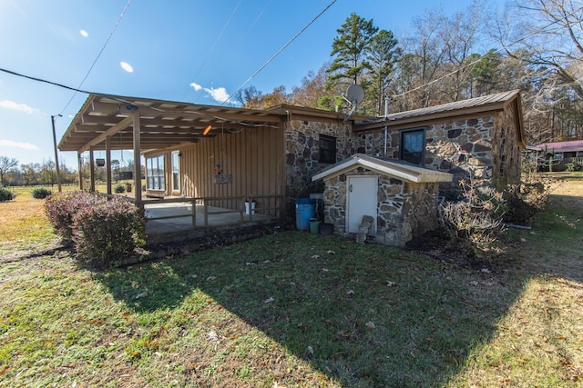 rear view of property with a patio area and a lawn