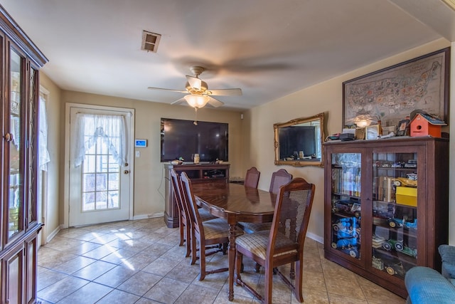 tiled dining room featuring ceiling fan