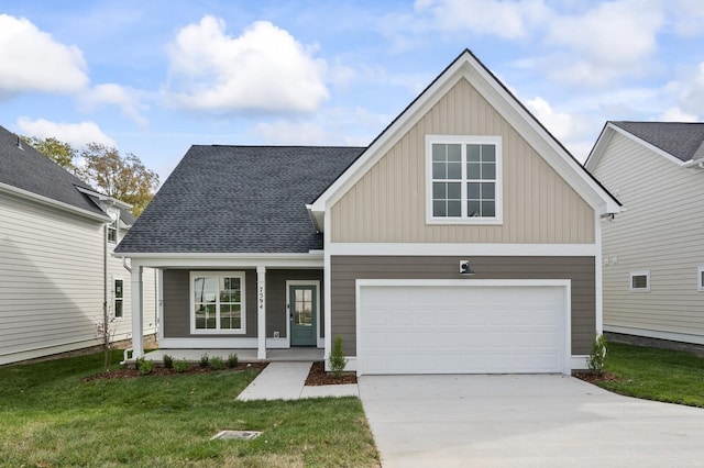 view of front of home with covered porch, a garage, and a front lawn