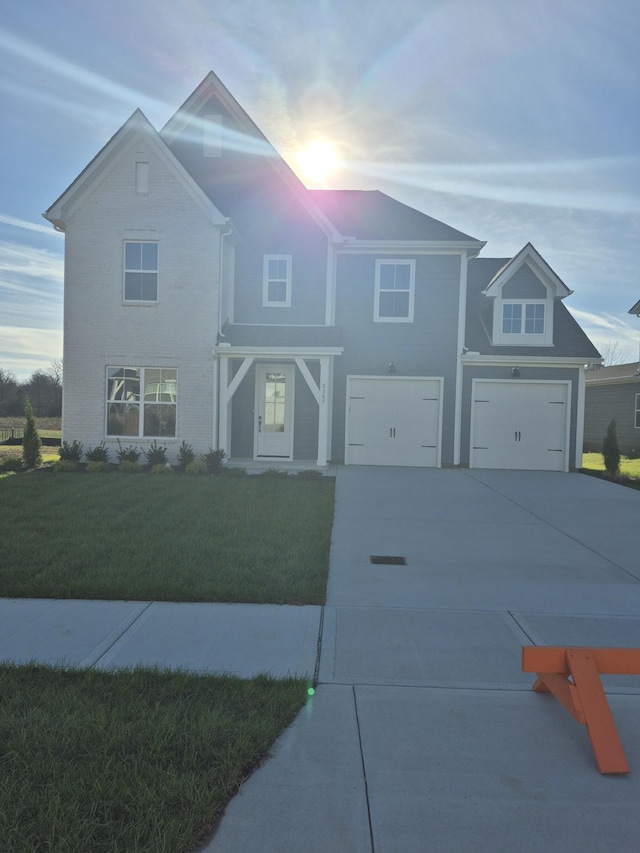 view of front of home with a garage and a yard