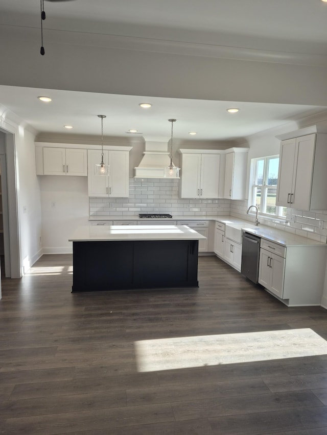 kitchen with custom exhaust hood, appliances with stainless steel finishes, decorative backsplash, and dark wood-type flooring